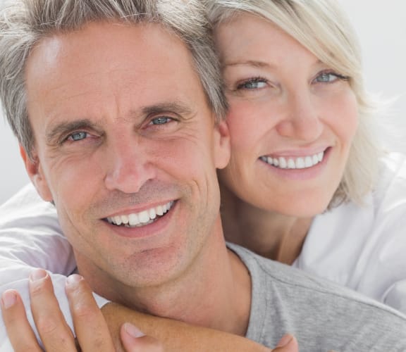 Mature couple holding each other and smiling